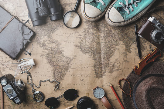 Travel Concept Background. Overhead View of Traveler's Accessories on Old Vintage Map
