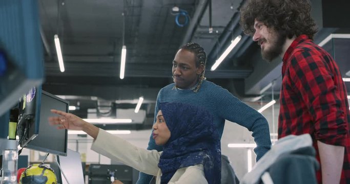 Young multiethnic business team of software developers working together using