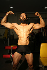 Bodybuilder posing in different poses demonstrating their muscles. Male showing muscles straining. Beautiful muscular body athlete, Sexy man, naked body, nude male. Sexy body. - Image