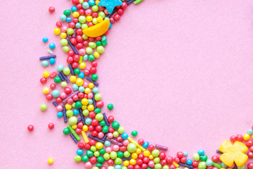 Colorful holiday background with candy on pink. Copy space for text. Greeting card for Easter, birthday. Flat lay .Top view. 