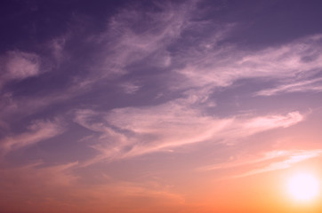Naklejka na ściany i meble Beautiful sky at sunset, cirrus clouds and bright sun.