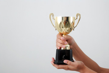 Man holding a champion golden trophy