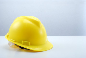 Fototapeta premium yellow hard hat on white table