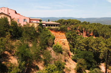 Fototapeta na wymiar Roussillon, red rocks colorful ochre canyon in Provence, landscape of France.