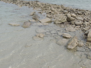 Stones and sand on Fuwairit Beach in Qatar