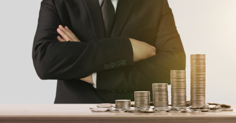 Coins stacked on each other in different positions,Man hand in business money