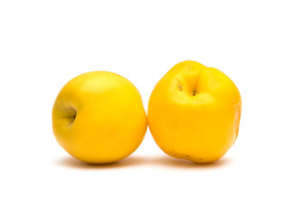 Juicy yellow nectarines on a white background