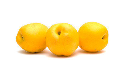 Juicy yellow nectarines on a white background