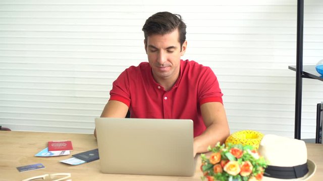 Hispanic man searching for travel deal on computer