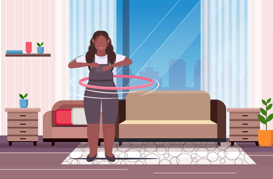 fat obese girl twisting hula hoop overweight african american woman training workout weight loss concept modern living room interior flat full length horizontal