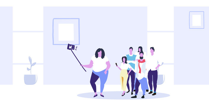 fat obese woman holding selfie stick businesswoman with casual colleagues group taking photo on smartphone camera coworkers team standing together modern office interior sketch full length horizontal