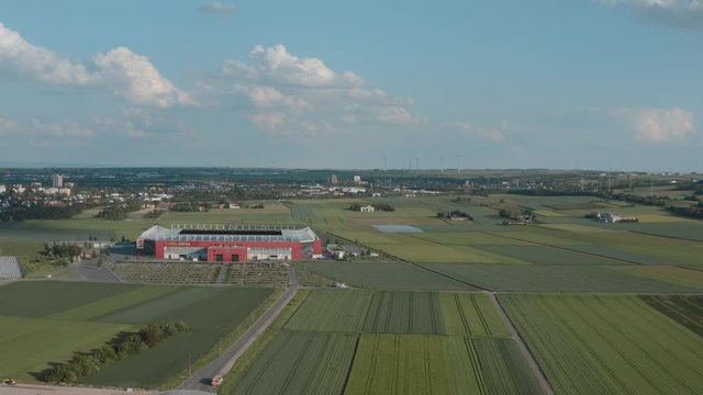 Drone / Aerial shot of the football stadium of the bundesliga team FSV Mainz 05 with field in the foreground on a sunny day, 25p