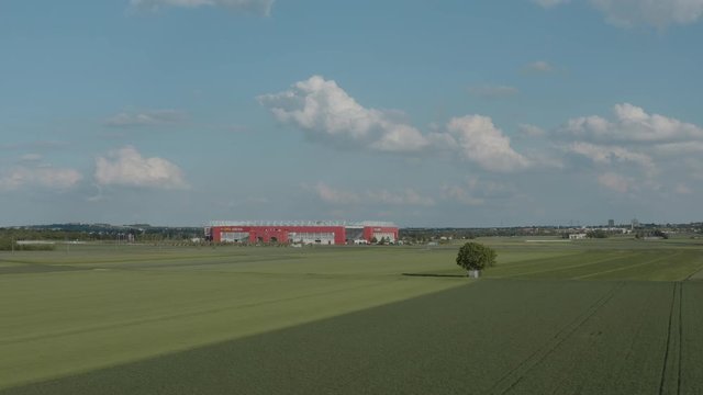 Drone / Aerial shot of the football stadium of the bundesliga team FSV Mainz 05 with field in the foreground on a sunny day, 25p