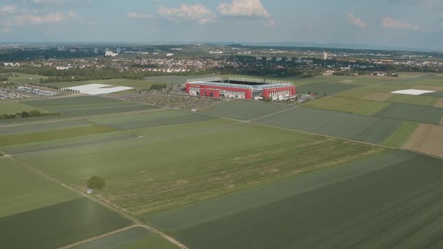 Drone / Aerial shot of the football stadium of the bundesliga team FSV Mainz 05 with field in the foreground on a sunny day, 25p