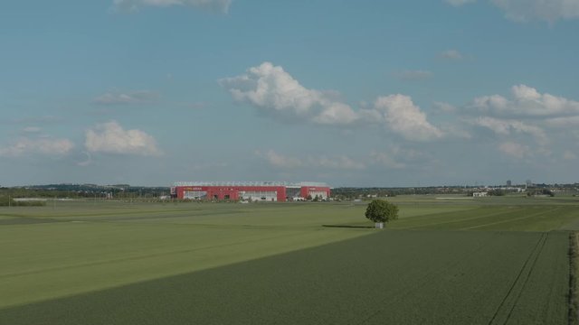 Drone / Aerial shot of the football stadium of the bundesliga team FSV Mainz 05 with field in the foreground on a sunny day, 30p