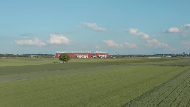 Drone / Aerial shot of the football stadium of the bundesliga team FSV Mainz 05 with field in the foreground on a sunny day, 30p