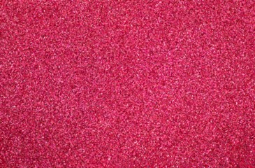 Pink rose sand textured background. Blurred grain surface.