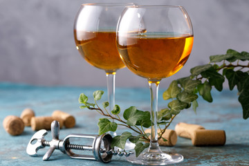 Two glasses with white wine on a textural background. Copy space. Place for your text.