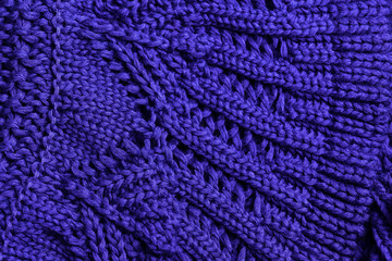 Knit texture of purple cotton knitted fabric with cable pattern as background.