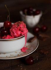 Homemade cherry ice cream on table