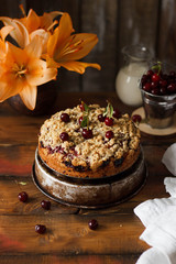 Homemade cherry pie on rustic background.