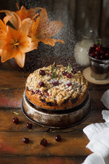Homemade cherry pie on rustic background.