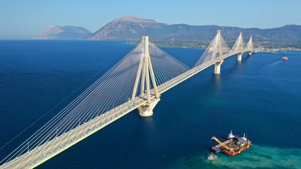 Poster Aerial drone panoramic photo of world famous cable suspension bridge of Rio - Antirio Harilaos Trikoupis, crossing Corinthian Gulf, mainland Greece to Peloponnese, Patras © aerial-drone
