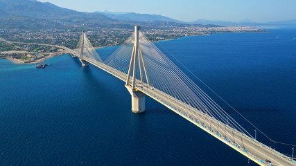 Aerial drone photo of world famous cable suspension bridge of Rio - Antirio Harilaos Trikoupis, crossing Corinthian Gulf, mainland Greece to Peloponnese, Patras