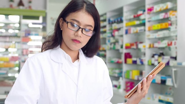 Beautiful asian pharmacist working in drugstore