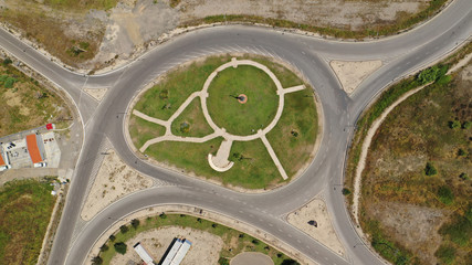 Aerial drone top view photo of modern roundabout as seen in low traffic motorway outside city centre