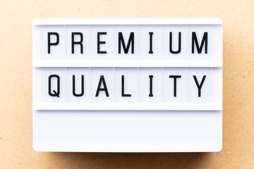 Lightbox with word premium quality on wood background