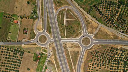 Aerial drone photo of modern motorway roundabouts of Ionia Odos near famous cable bridge of Rio - Antirio Harilaos Trikoupis, Antirio, Greece