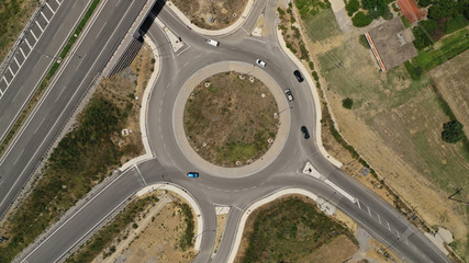Aerial drone top view photo of modern roundabout as seen in low traffic motorway outside city centre