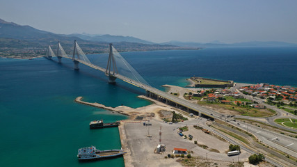 Aerial drone photo of world famous cable suspension bridge of Rio - Antirio Harilaos Trikoupis, crossing Corinthian Gulf, mainland Greece to Peloponnese, Patras