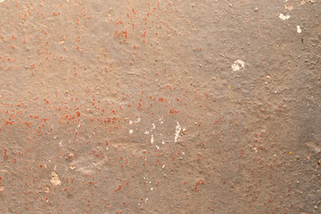 A scuffed stone surface painted in grey