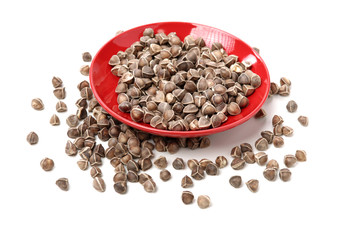 Organic Wingless Moringa (Moringa oleifera) seeds on white background