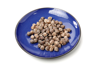 Organic Wingless Moringa (Moringa oleifera) seeds on white background