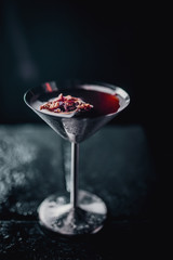 black red coctail in metal blow on black with orange