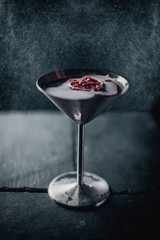 black red coctail in metal blow on black with orange