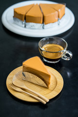 Tea cake on wooden plate with black background