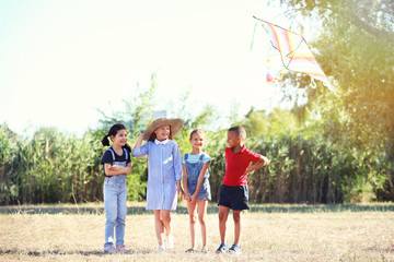 Little children flying kite outdoors