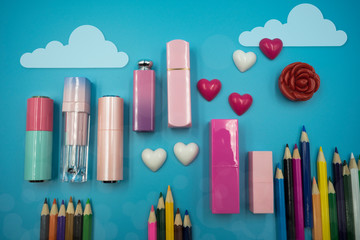 Beauty and Make-up accessories lipstick make-up spnoge, blush decorate cutie style lay flat top view on sky blue background.