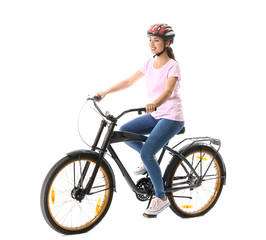 Obraz premium Beautiful young woman riding bicycle against white background