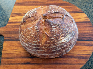 Close up of a Loaf of fresh hot homemade sour dough bread out of the oven baked 