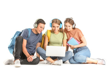 Portrait of young students with laptop on white background