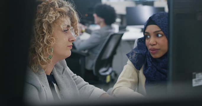 Young multiethnic business team of software developers working together using