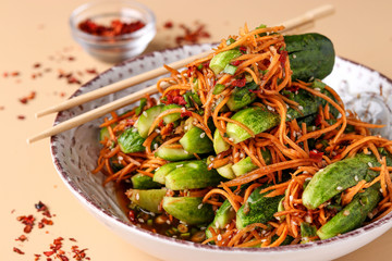 Traditional Korean cucumber kimchi snack: cucumbers stuffed with carrots, green onions, garlic and sesame, fermented vegetables, horizontal orientation