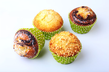 Assorted with Delicious homemade cupcakes with raisins and chocolate isolated on white background. Muffins. Top view. Copy space.