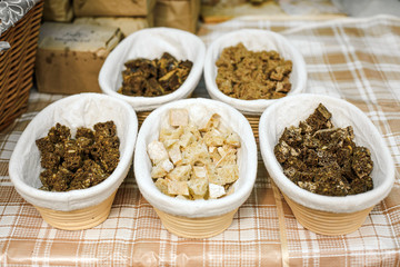 Tasting of bread at the craft market. Baskets with pieces of different bread on the counter.