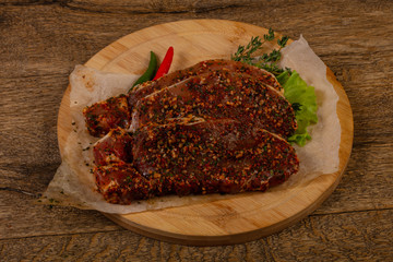 Raw marinated pork steak